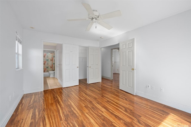 94-1092 Kikepa St Unit 179, Waipahu, HI 96797 - unfurnished bedroom with wood finished floors, connected bathroom, ceiling fan, and a closet