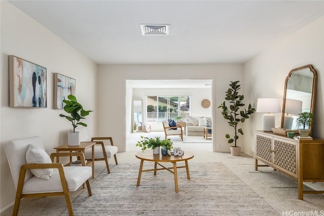 sitting room with carpet floors and visible vents