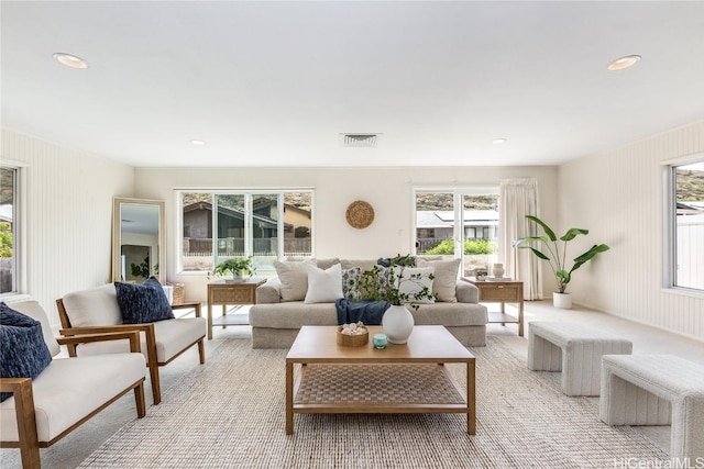 living area featuring visible vents and recessed lighting