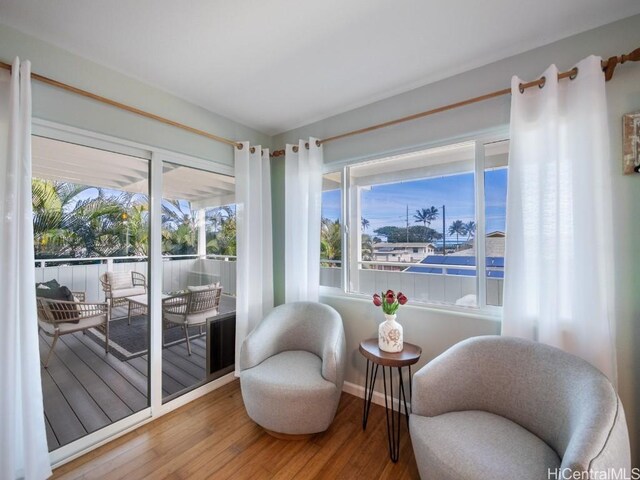 living area with hardwood / wood-style flooring