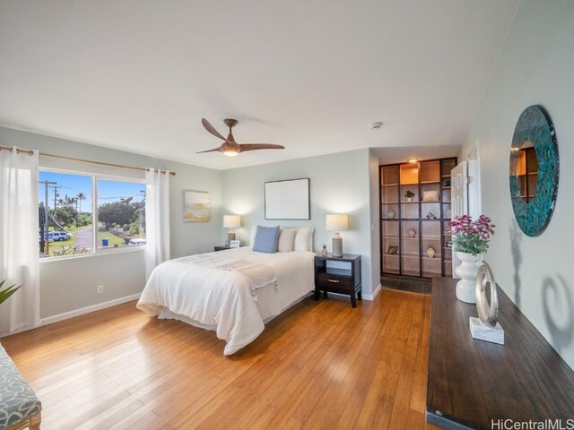 bedroom with light hardwood / wood-style flooring and ceiling fan