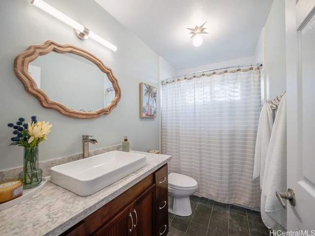 bathroom with vanity, tile patterned floors, and toilet