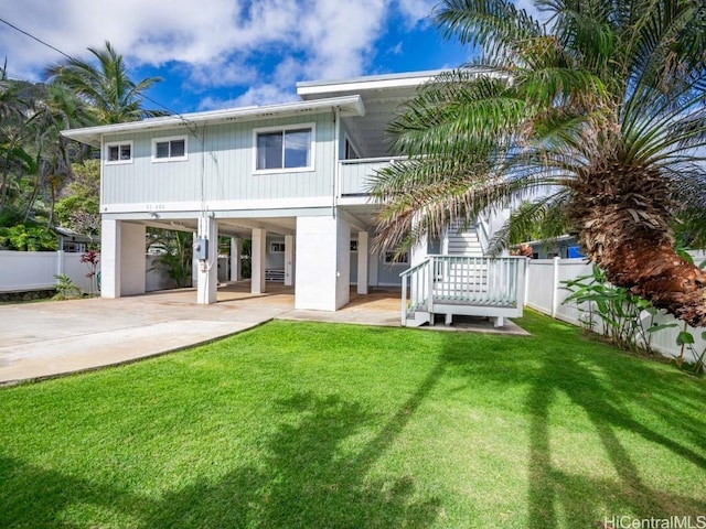 back of house featuring a yard and a carport