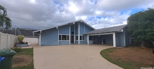 rear view of house featuring a garage