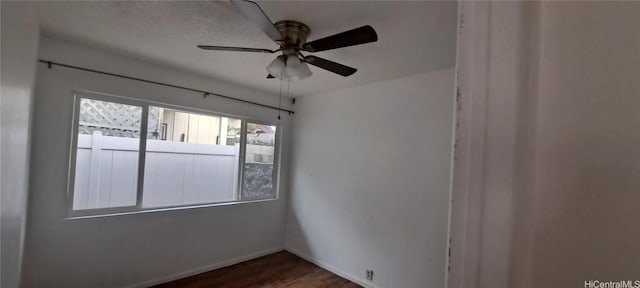 spare room featuring hardwood / wood-style floors and ceiling fan