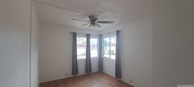 empty room with ceiling fan, a textured ceiling, and light wood-type flooring