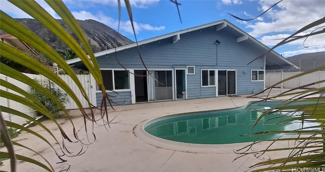 view of swimming pool with a mountain view and a patio area