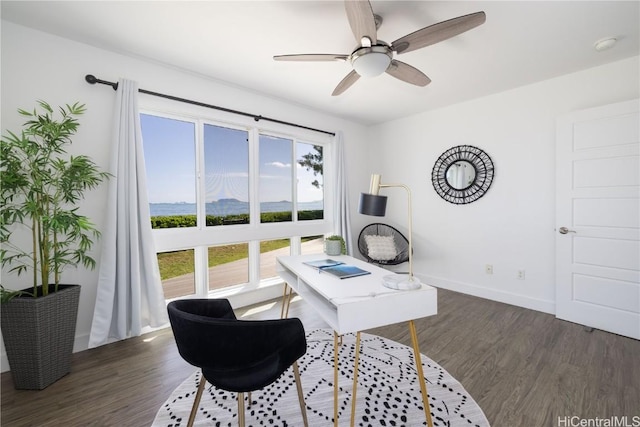 office area featuring a mountain view, dark wood-type flooring, and ceiling fan