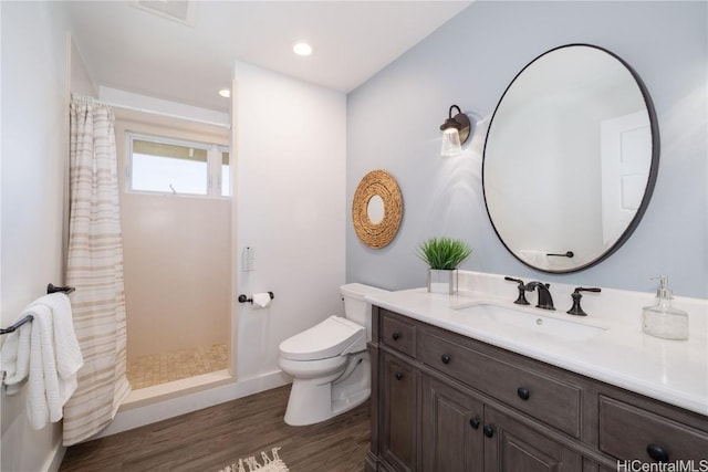 bathroom featuring a shower with curtain, vanity, toilet, and hardwood / wood-style floors