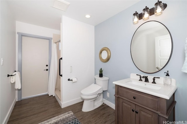 bathroom with a shower with curtain, vanity, hardwood / wood-style floors, and toilet