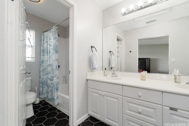 full bathroom with shower / tub combo with curtain, vanity, toilet, and tile patterned flooring