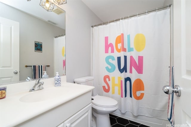 bathroom featuring tile patterned floors, toilet, and vanity