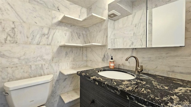 bathroom featuring toilet and vanity