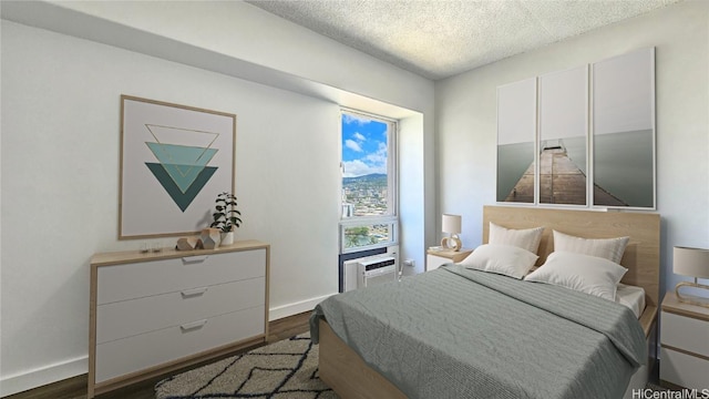 bedroom with a textured ceiling and dark hardwood / wood-style floors