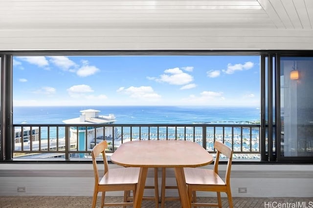 balcony featuring a water view and a view of the beach