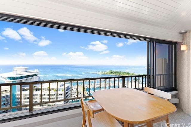 balcony featuring a water view and a view of the beach