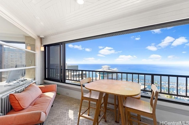 balcony with a water view and an outdoor hangout area