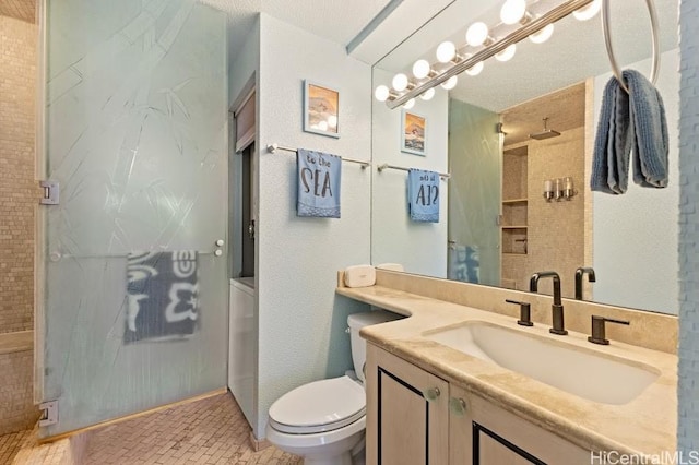 bathroom with vanity, an enclosed shower, and toilet