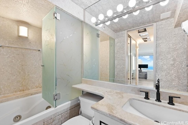 full bathroom with vanity, shower / bath combination with glass door, and toilet