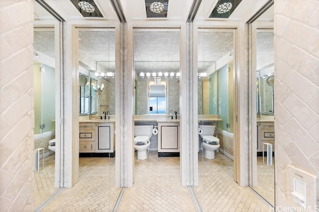 bathroom featuring vanity, tile patterned floors, and toilet