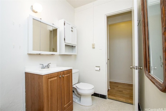 bathroom featuring toilet, vanity, and tile patterned flooring