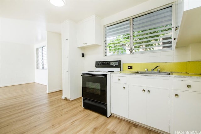 kitchen featuring sink, white cabinets, light hardwood / wood-style flooring, and range with electric cooktop