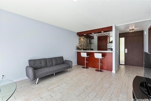 interior space with a textured ceiling and light hardwood / wood-style floors