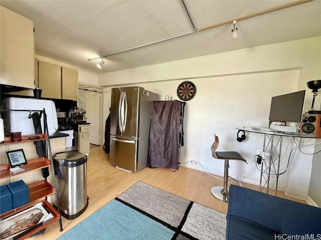 kitchen with light hardwood / wood-style flooring and stainless steel fridge