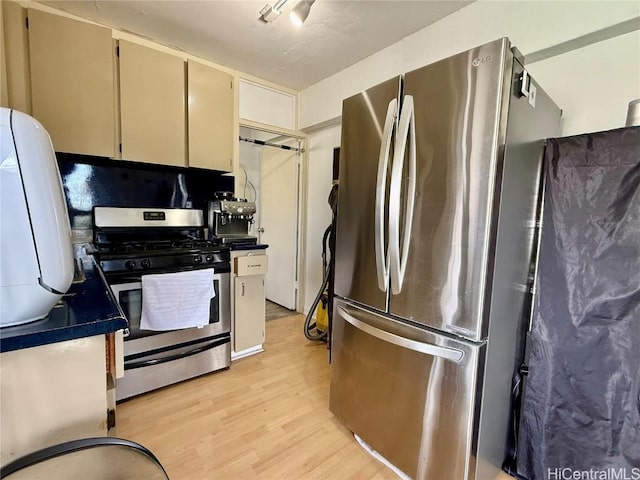 kitchen with appliances with stainless steel finishes and light hardwood / wood-style flooring