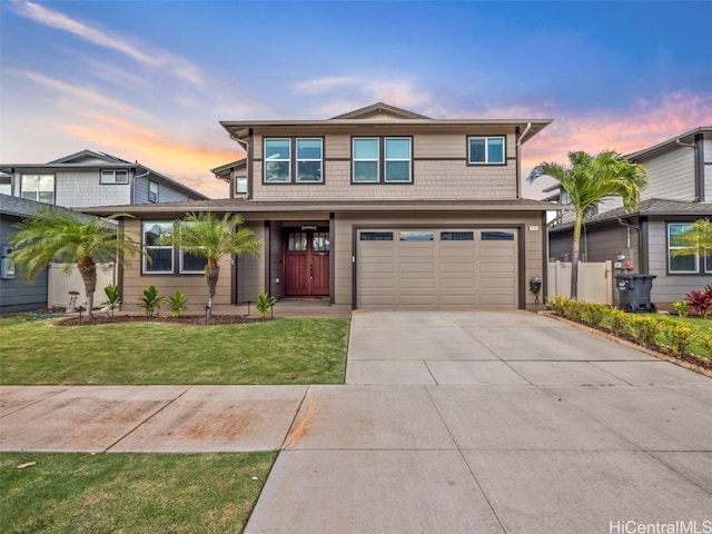 front of property featuring a garage and a lawn