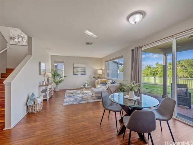 dining room featuring a healthy amount of sunlight and hardwood / wood-style flooring