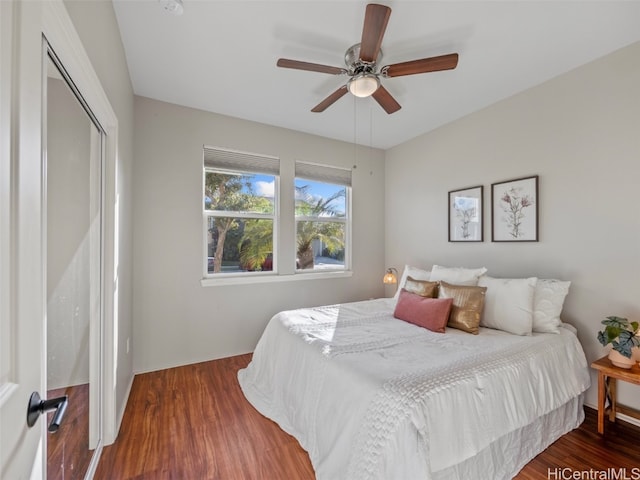 bedroom featuring ceiling fan, a closet, and wood-type flooring