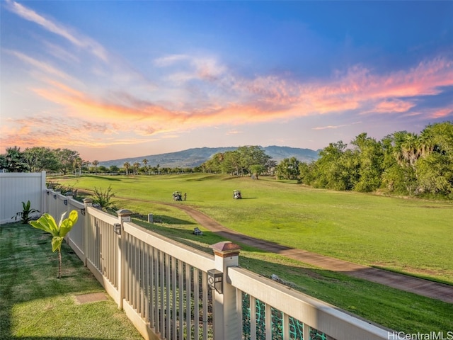 yard at dusk featuring a mountain view