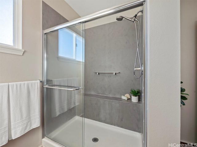 bathroom featuring walk in shower and plenty of natural light