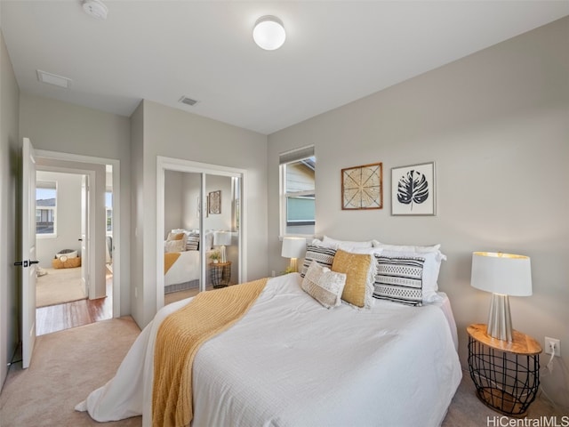 bedroom with a closet and light colored carpet