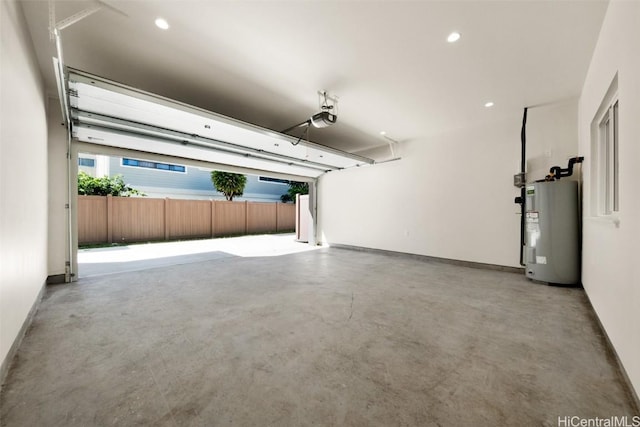 garage with a garage door opener and electric water heater