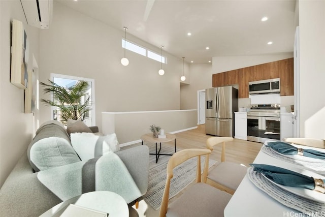 living room with high vaulted ceiling and light hardwood / wood-style floors