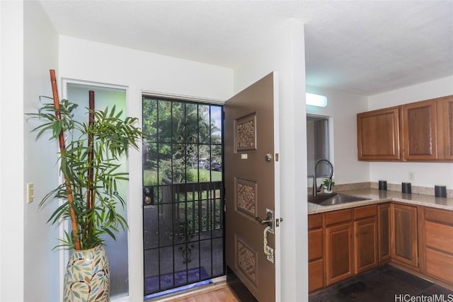 kitchen with light stone countertops and sink