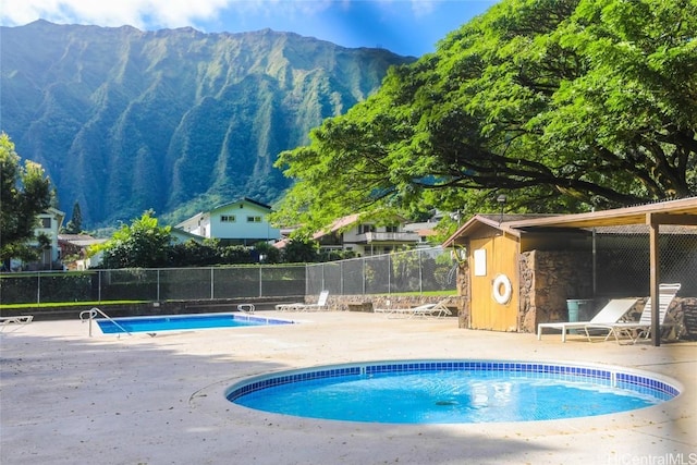 view of pool featuring a mountain view and a patio area