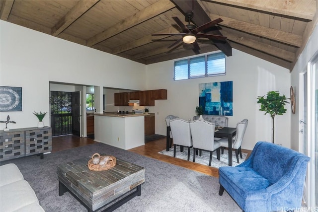 living room with hardwood / wood-style flooring, a healthy amount of sunlight, vaulted ceiling with beams, and wooden ceiling