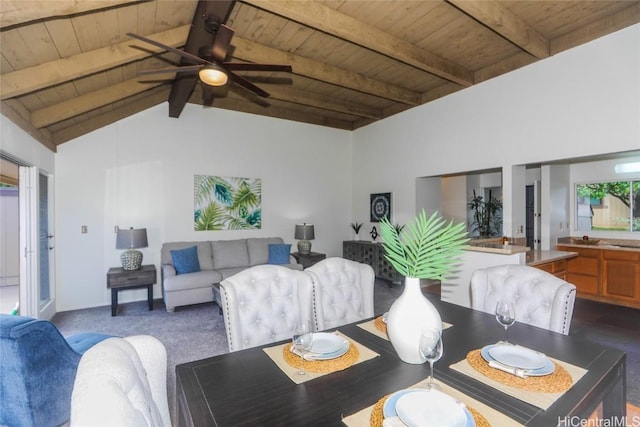 dining area featuring carpet floors, vaulted ceiling with beams, ceiling fan, and wood ceiling