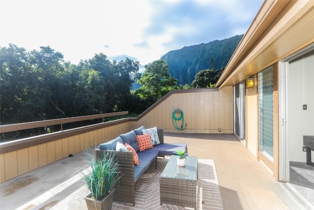 view of patio with an outdoor living space and a mountain view