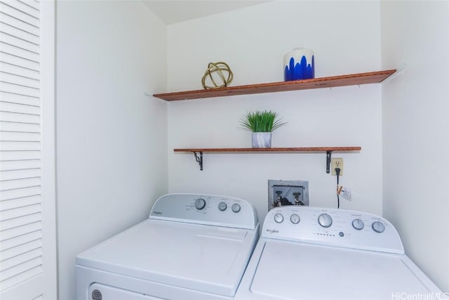 clothes washing area featuring separate washer and dryer