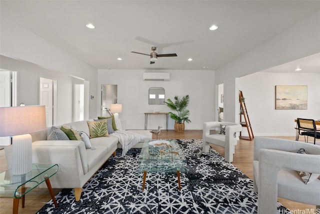 living room with ceiling fan, light hardwood / wood-style flooring, and a wall mounted air conditioner