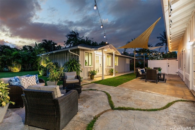 patio terrace at dusk featuring an outdoor hangout area