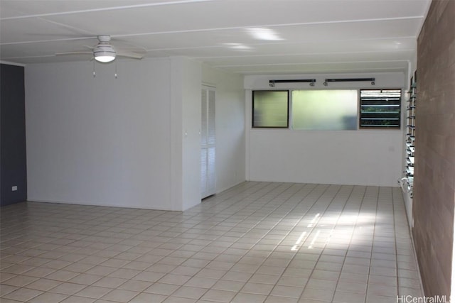 tiled empty room with ceiling fan