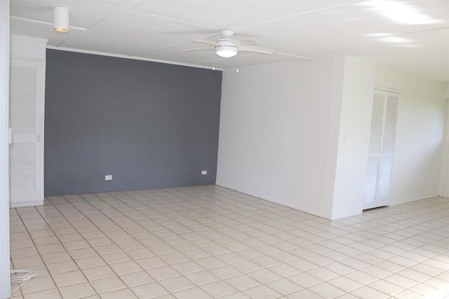 spare room featuring ceiling fan and light tile patterned flooring