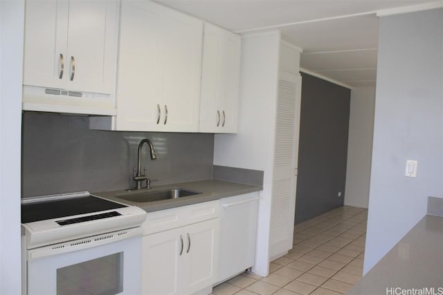 kitchen featuring light tile patterned floors, sink, white appliances, and white cabinets