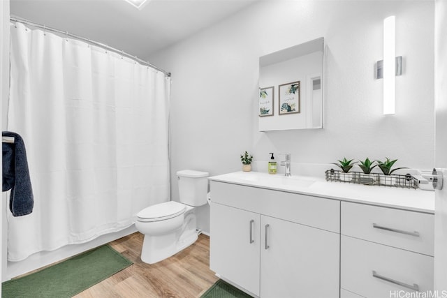 full bathroom featuring hardwood / wood-style flooring, toilet, shower / bathtub combination with curtain, and vanity