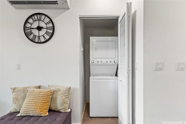 washroom featuring stacked washer and clothes dryer and a wall mounted air conditioner